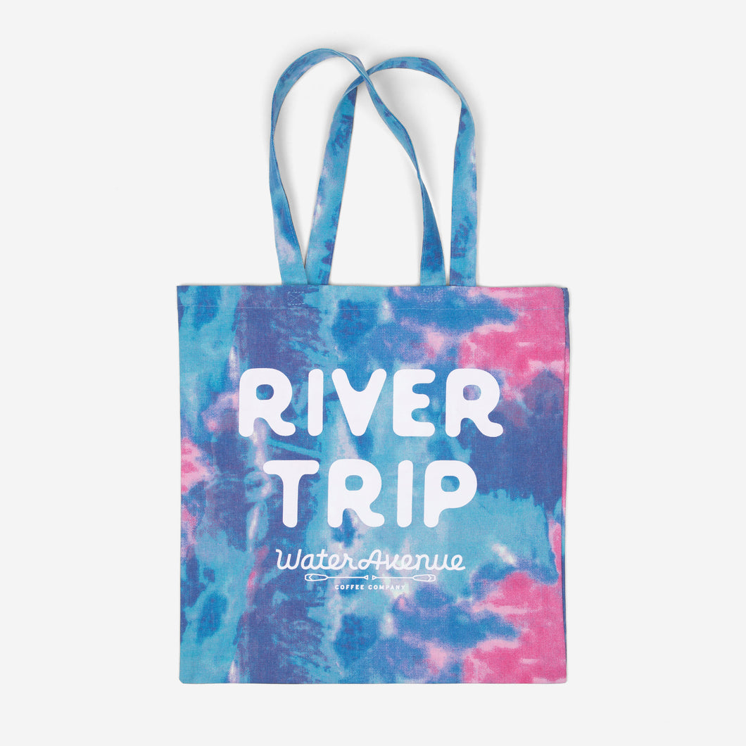 River Trip Tote Bag - a blue, pink, and purple tie dye canvas tote with Water Avenue logo and River Trip screenprinted on front.
