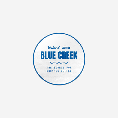 Water Avenue Blue Creek - The Source for Organic Coffee, circular white sticker with blue detailing.