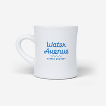 Load image into Gallery viewer, Water Avenue white diner mug with blue logo, shot from the back
